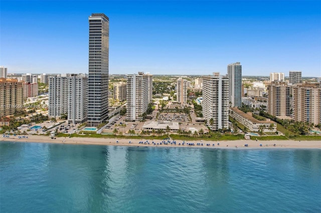 aerial view with a city view, a view of the beach, and a water view