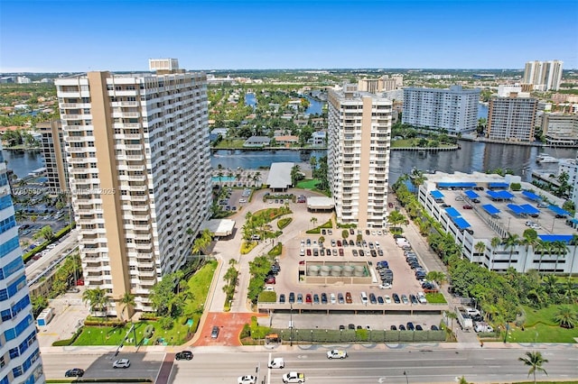 drone / aerial view with a city view and a water view