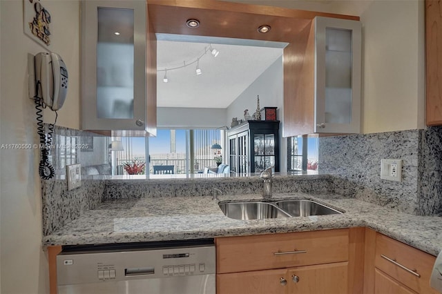 kitchen featuring dishwasher, a healthy amount of sunlight, tasteful backsplash, and a sink