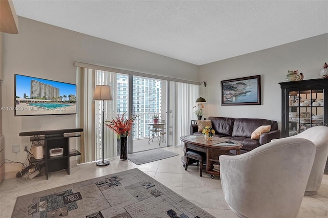 living area with light tile patterned floors and a textured ceiling