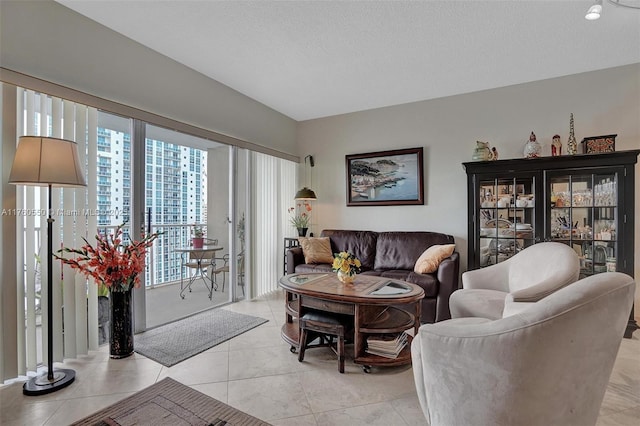 living room featuring light tile patterned floors and a textured ceiling