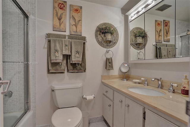 bathroom with visible vents, toilet, vanity, and bath / shower combo with glass door