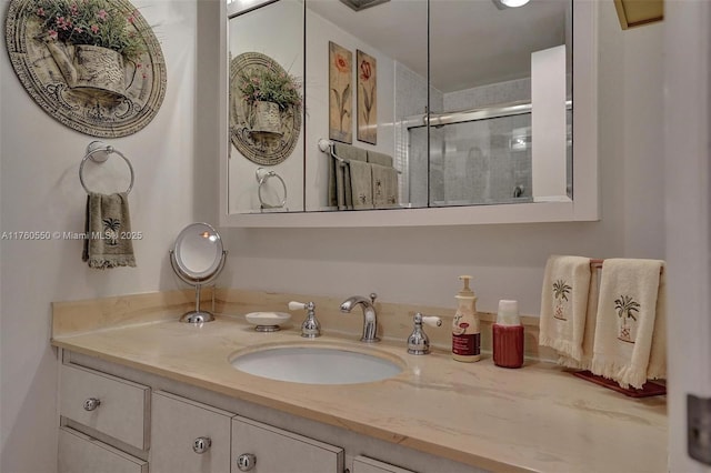 full bath with a shower stall and vanity