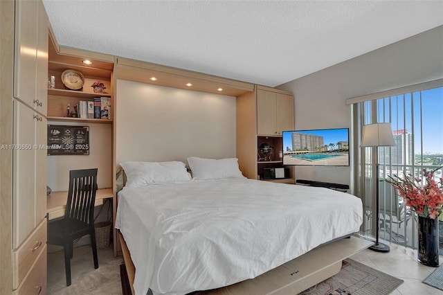 bedroom featuring light tile patterned floors and a textured ceiling