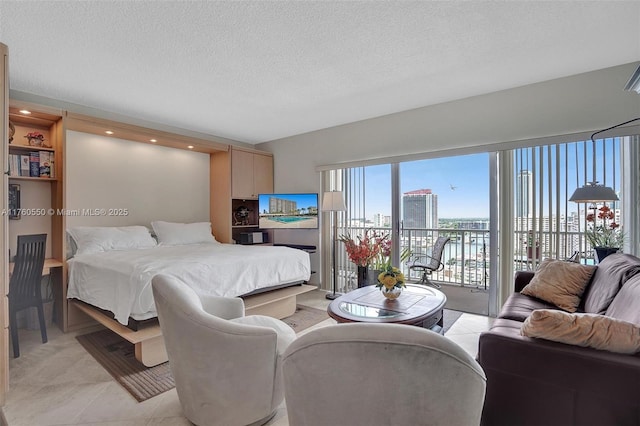 bedroom with light tile patterned floors, a textured ceiling, and access to outside