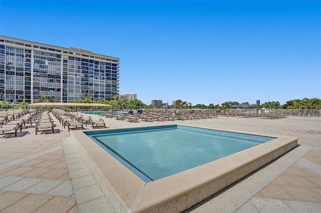 pool featuring a patio area and fence