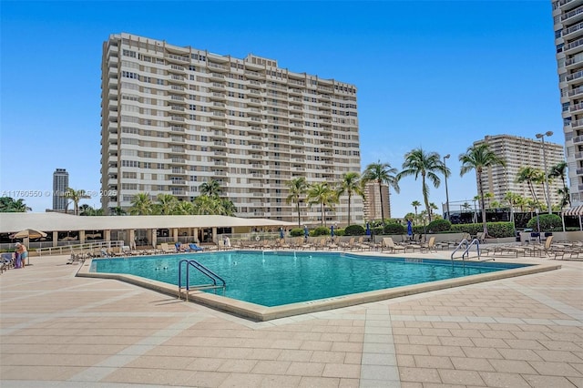 pool with fence and a patio area