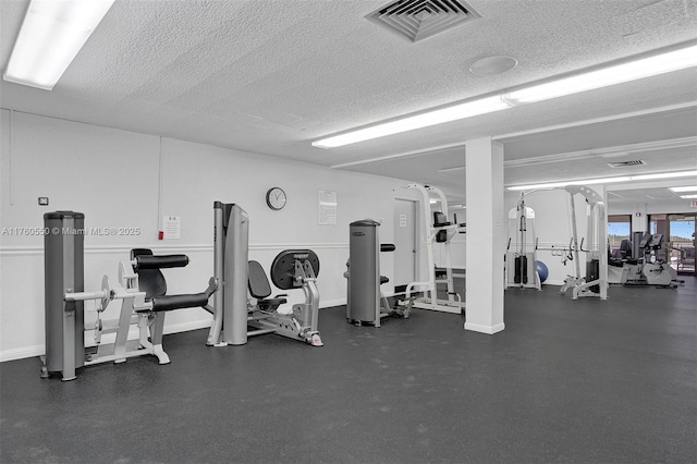 workout area with visible vents and a textured ceiling