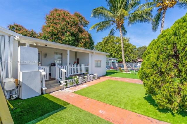 exterior space featuring covered porch and fence