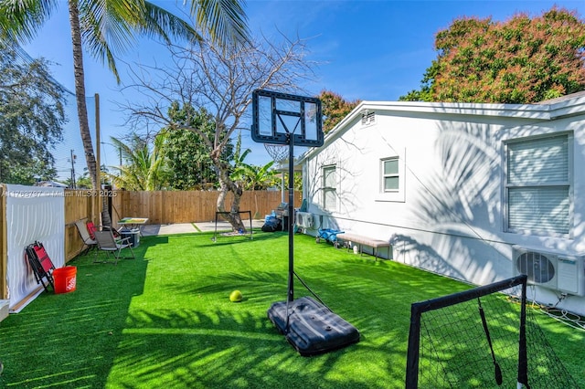 view of yard with ac unit and a fenced backyard