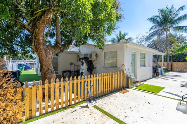 view of front of house with a fenced front yard, stucco siding, and driveway