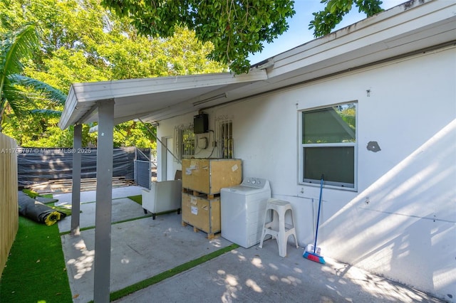 view of patio with washer / dryer and fence