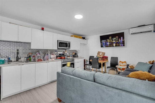 living area featuring a wall mounted air conditioner and light wood-type flooring