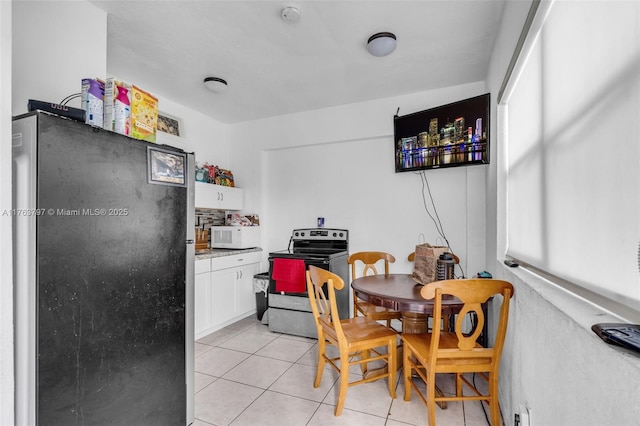 dining space featuring light tile patterned flooring