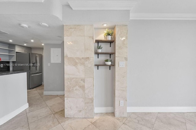 interior space featuring baseboards and ornamental molding