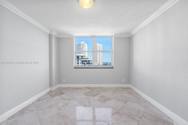 unfurnished room featuring baseboards and crown molding