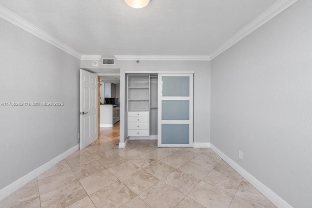 unfurnished bedroom featuring a closet, visible vents, baseboards, and ornamental molding