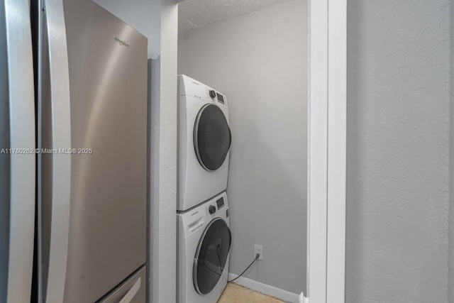 laundry room featuring laundry area and stacked washer / drying machine