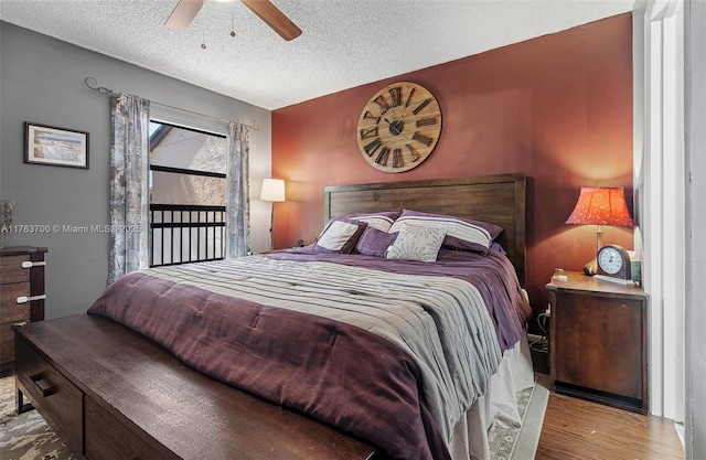 bedroom featuring ceiling fan, a textured ceiling, and wood finished floors