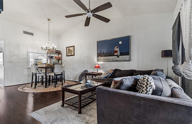 living area with visible vents, vaulted ceiling, ceiling fan with notable chandelier, wood finished floors, and a textured ceiling