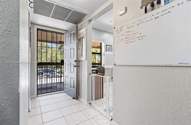 3059 Carambola Cir S Unit 2033, Coconut Creek, FL 33066 - tiled foyer entrance featuring a textured wall and plenty of natural light