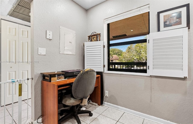 home office with electric panel, baseboards, tile patterned floors, and a textured wall