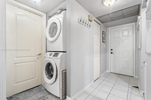 3059 Carambola Cir S Unit 2033, Coconut Creek, FL 33066 - laundry area with estacked washer and dryer, baseboards, and light tile patterned floors