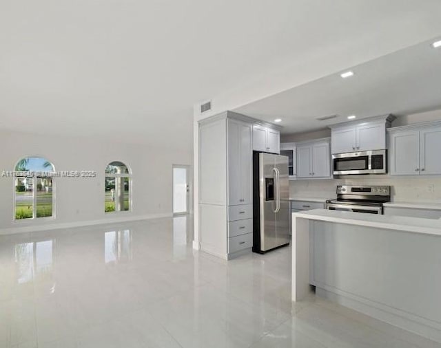 kitchen featuring visible vents, open floor plan, recessed lighting, appliances with stainless steel finishes, and light countertops