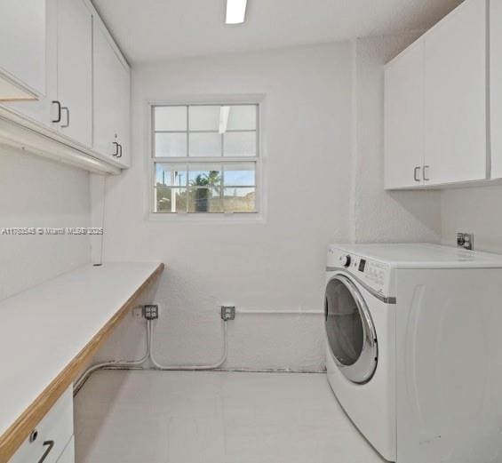 laundry area with washer / dryer and cabinet space