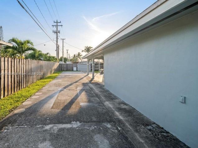 view of side of home featuring stucco siding and a fenced backyard