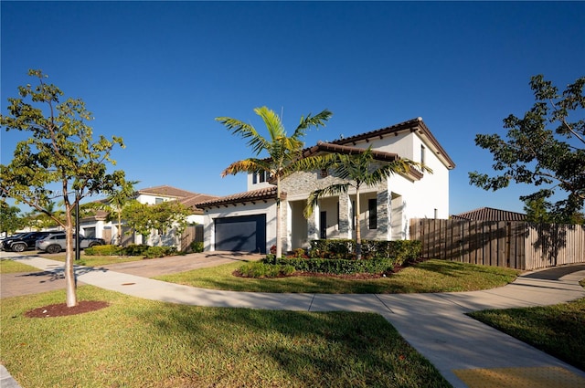 mediterranean / spanish-style house featuring fence, driveway, stucco siding, a garage, and a tiled roof