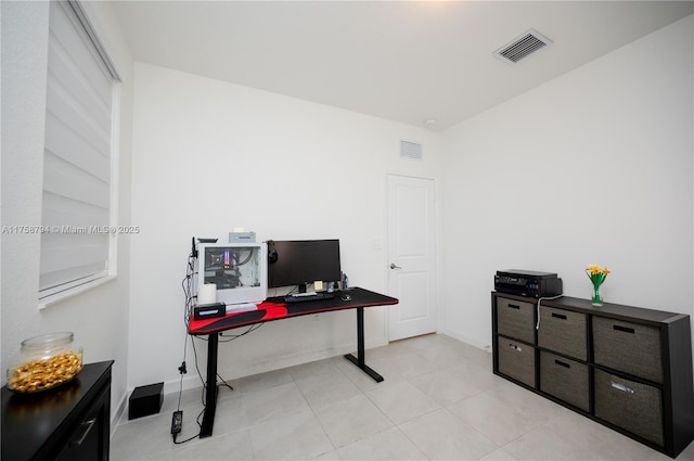 office area with light tile patterned floors, baseboards, and visible vents