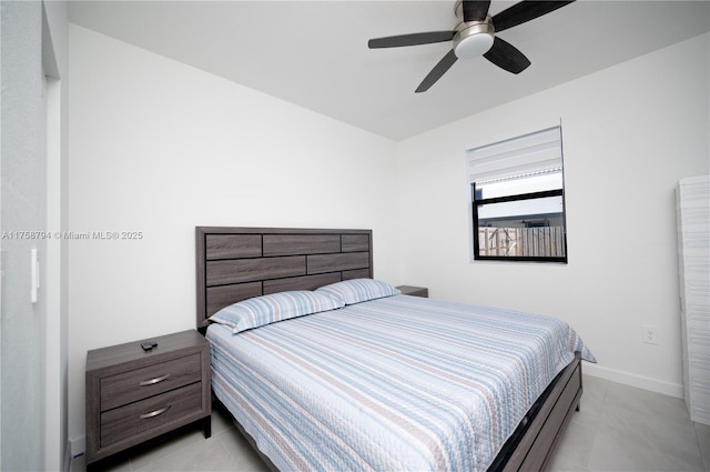 bedroom featuring light tile patterned floors, baseboards, and ceiling fan