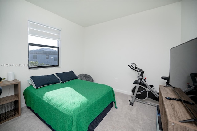 carpeted bedroom featuring baseboards