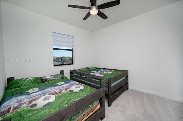 carpeted bedroom featuring a ceiling fan and baseboards