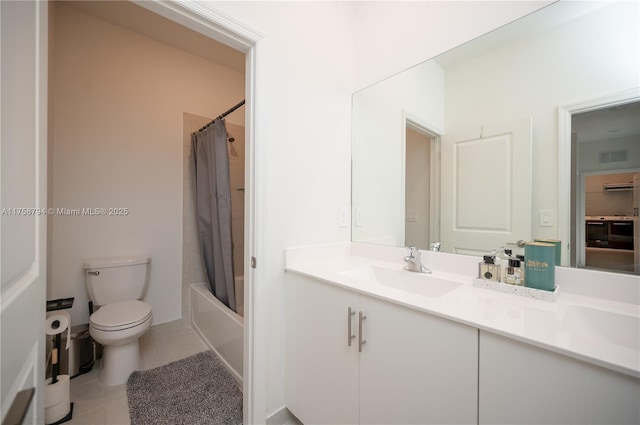 bathroom featuring visible vents, toilet, a sink, tile patterned flooring, and double vanity