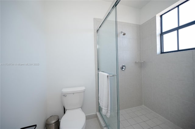 bathroom with a shower stall and toilet