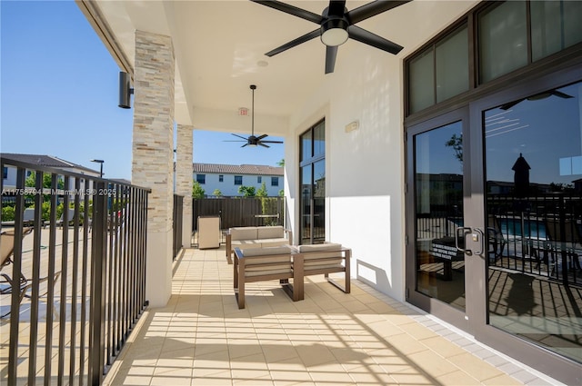 balcony with an outdoor hangout area and ceiling fan