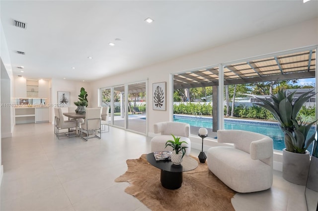 living room featuring recessed lighting and visible vents