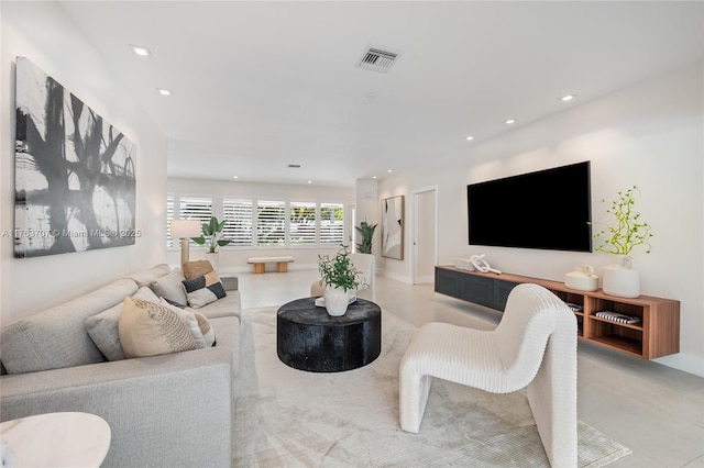 living area featuring visible vents and recessed lighting