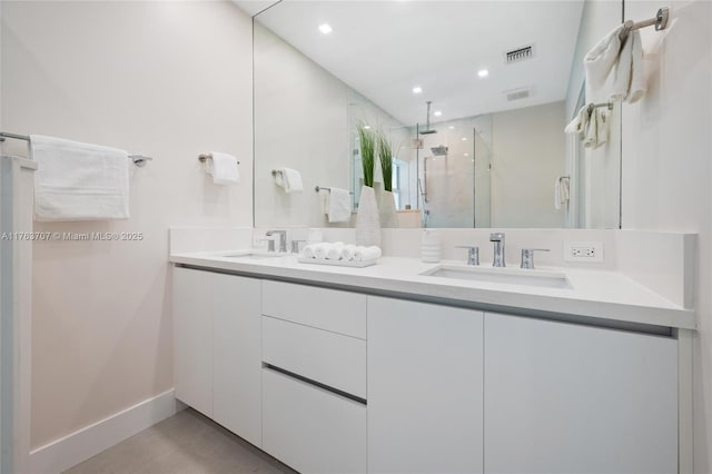 bathroom featuring a sink, visible vents, a stall shower, and double vanity