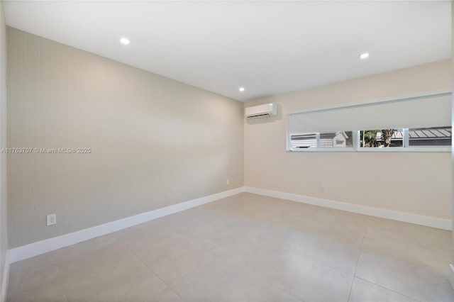 unfurnished room with recessed lighting, a wall mounted air conditioner, and baseboards