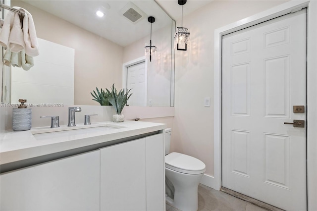 bathroom featuring tile patterned flooring, visible vents, toilet, and vanity