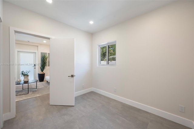 unfurnished room with recessed lighting, baseboards, and vaulted ceiling