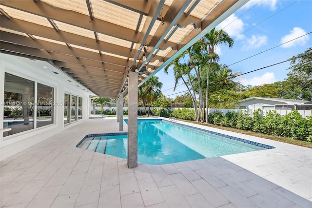 view of swimming pool featuring a patio, a fenced in pool, fence, and a pergola