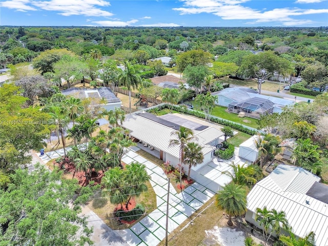 drone / aerial view with a wooded view