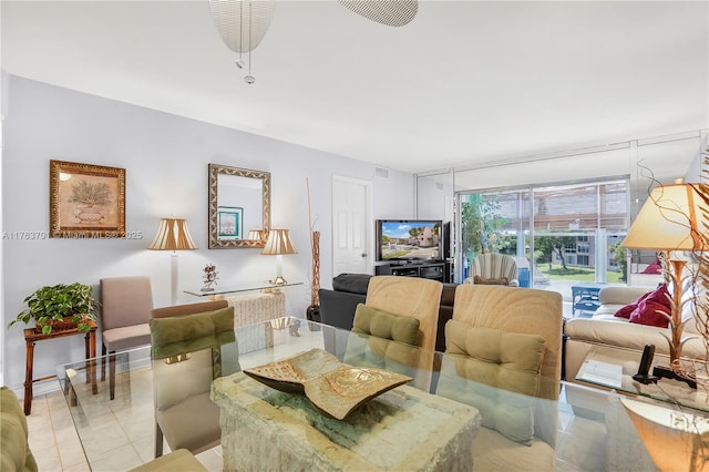 living room featuring light tile patterned floors and visible vents