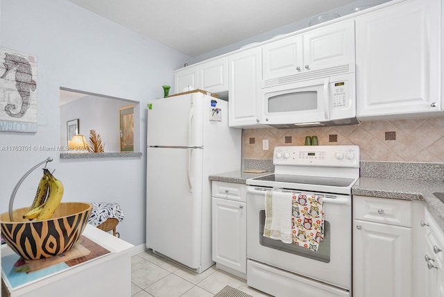 kitchen featuring white appliances, tasteful backsplash, and white cabinets