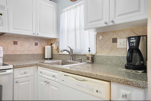 kitchen featuring a sink, decorative backsplash, white appliances, and white cabinets