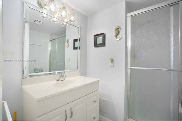 bathroom with a stall shower and vanity